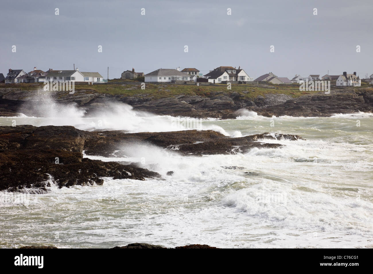 Trearddur Bay, Anglesey, North Wales, UK. View across rough stormy sea with waves crashing on rocks on exposed west coast Stock Photo