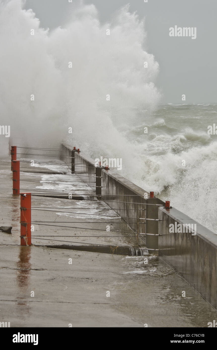 Gale force winds bring huge waves to pound the harbour wall Brighton Marina East Sussex. Stock Photo
