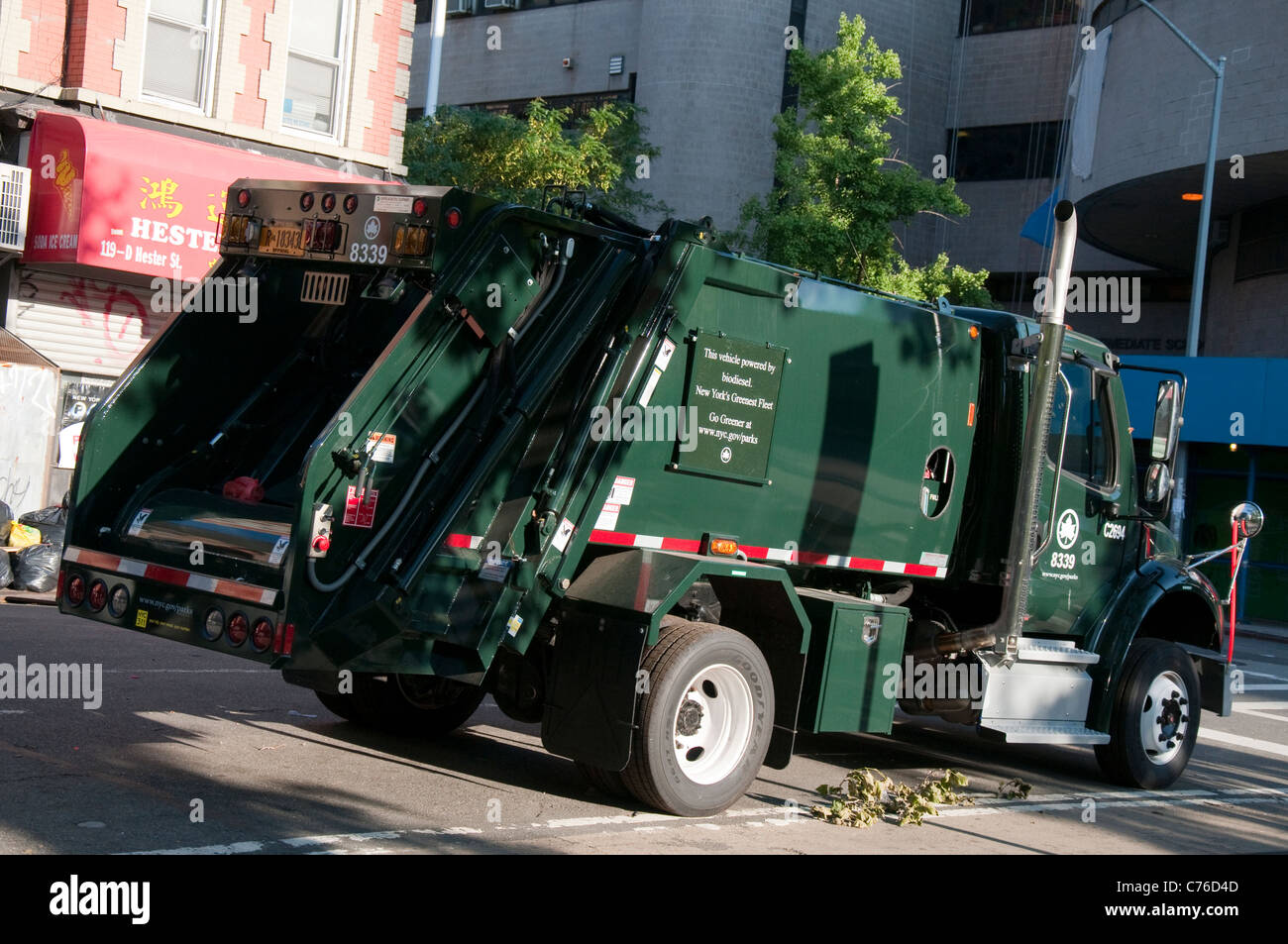 A trash truck, powered by Bio Diesel in Chinatown, New York USA Stock ...