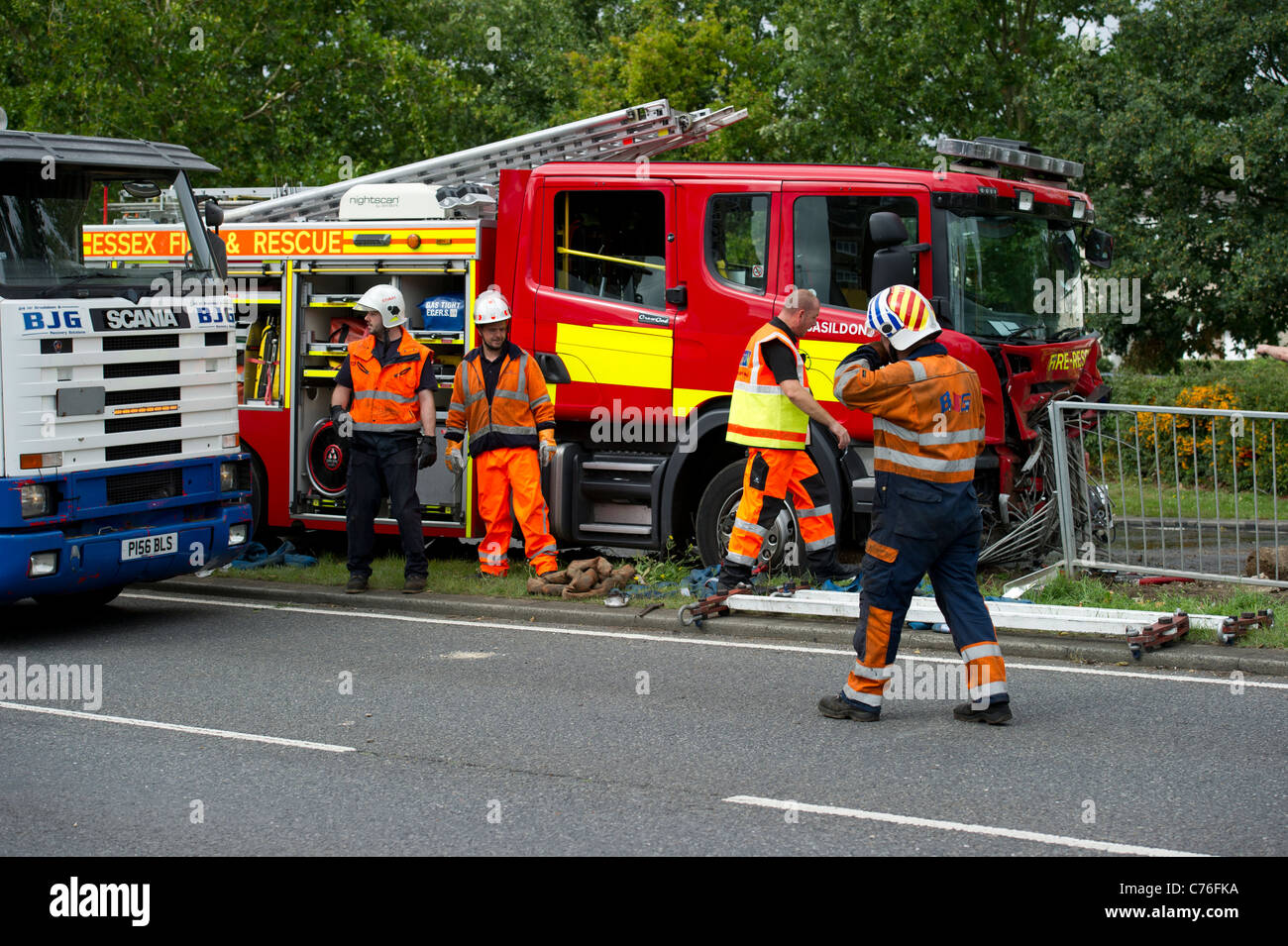 Recovery workers preparing to recover a fire engine for forensic examination by police after a serious road traffic collision. Stock Photo