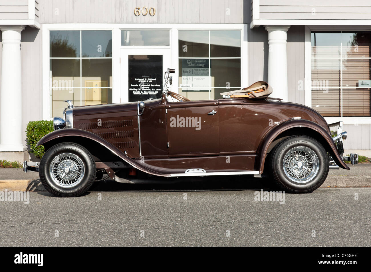 superb restored 1931 vintage chestnut brown parked Ford Model A cabriolet convertible car with chrome wire wheels & top down Stock Photo