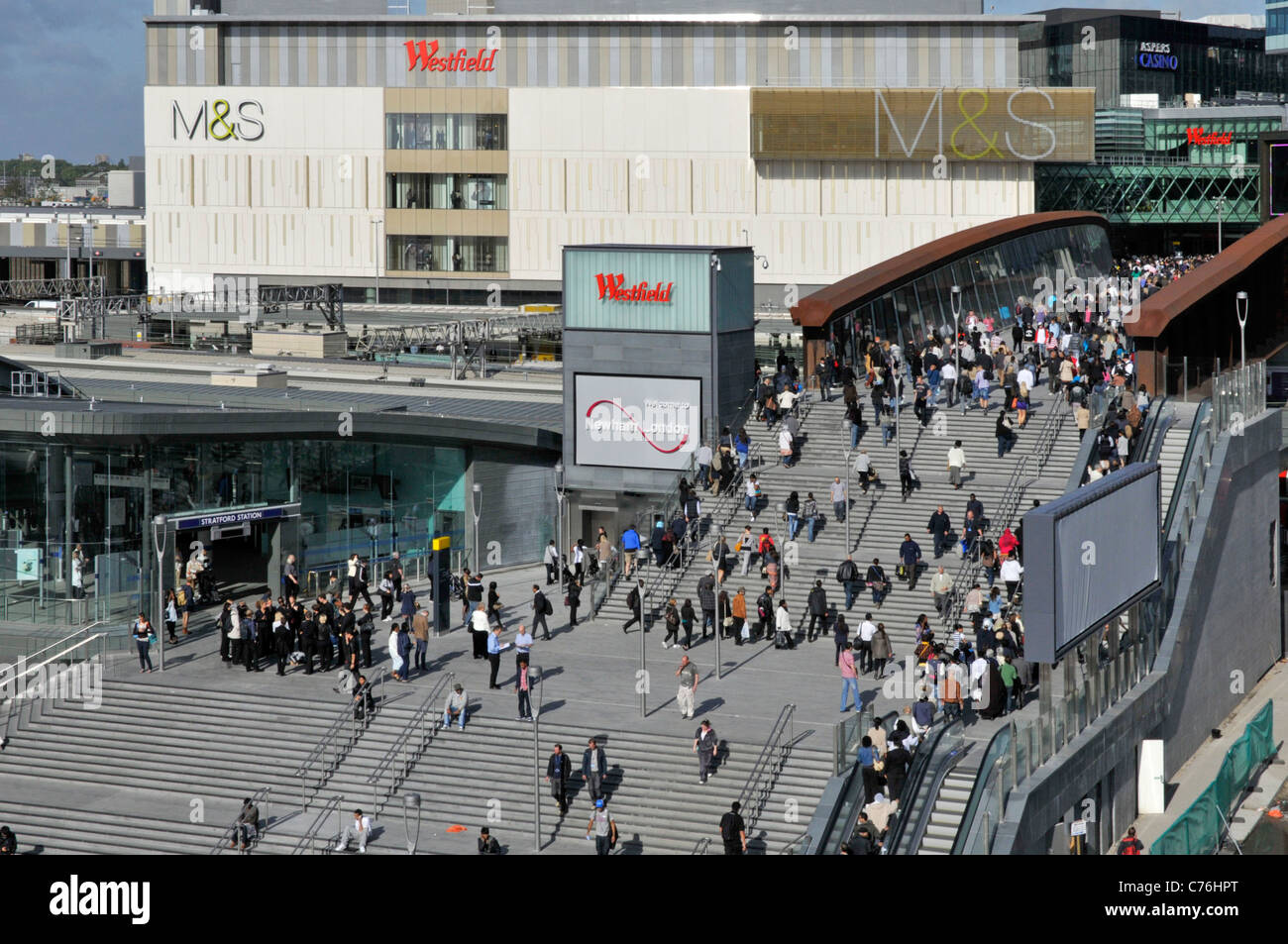 Westfield Shopping Centre & Marks and Spencer store building above entrance for people shoppers on bridge with station exit Stratford East London UK Stock Photo