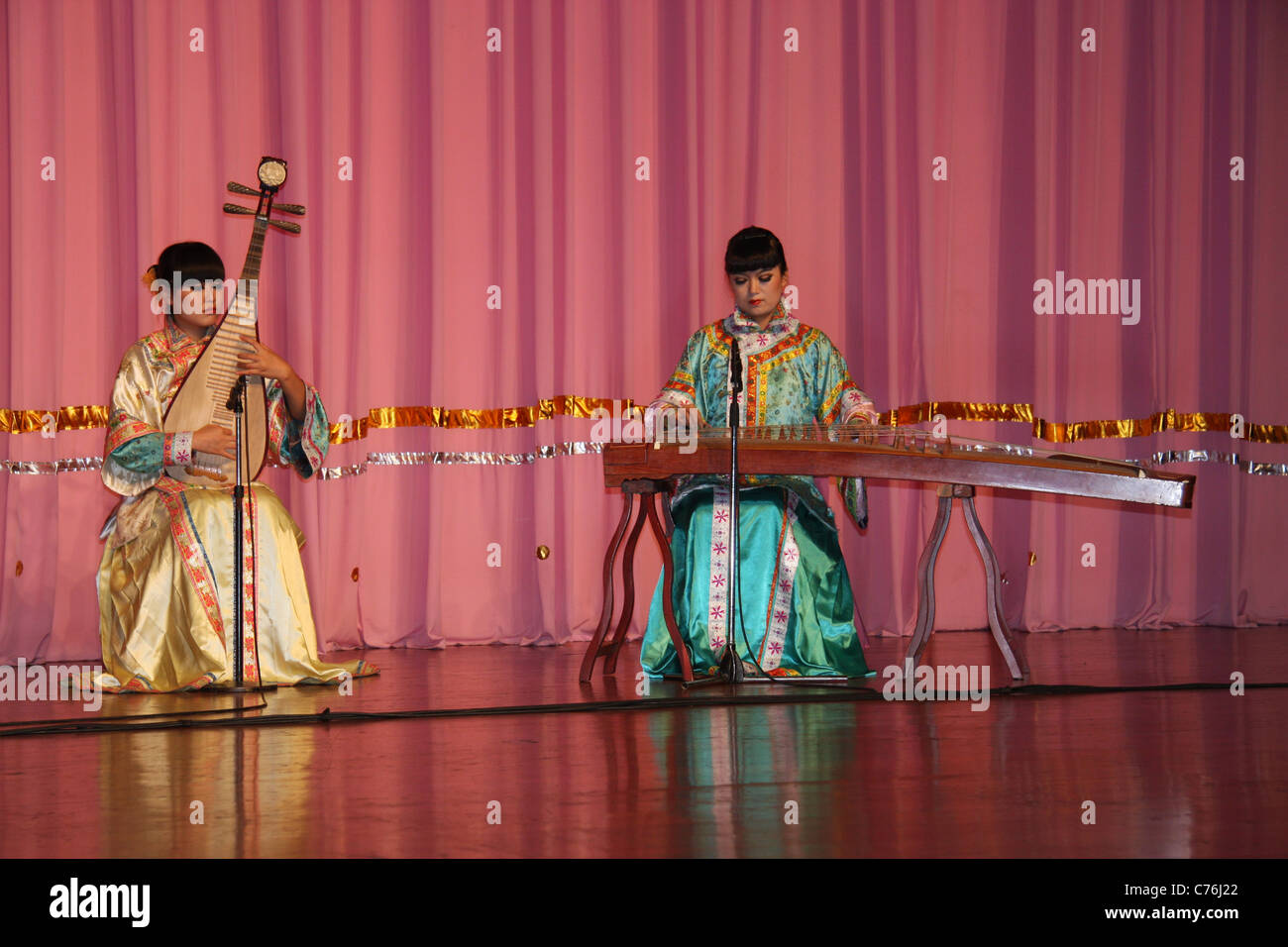 Two female musicians playing traditional stringed instruments at Tang dynasty dinner show, Xian
