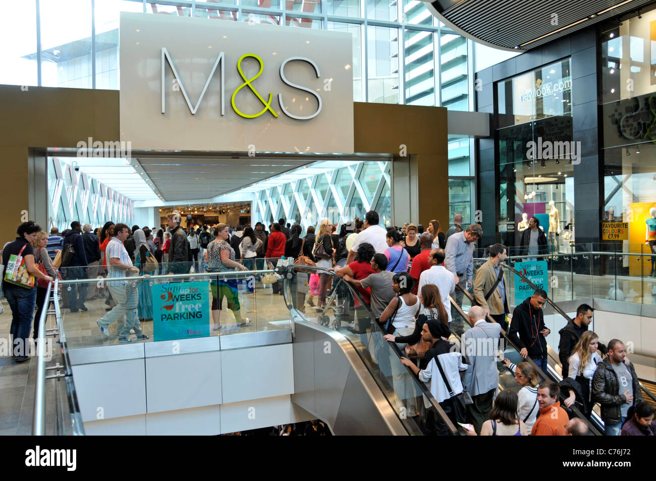 Shopping mall interior escalators giving access to M&S store at the Stratford City Westfield shopping centre London England UK Stock Photo
