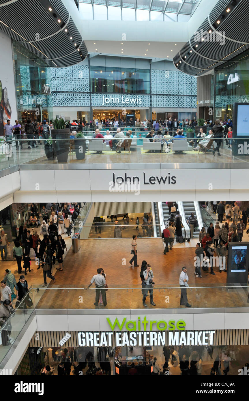 John Lewis department store entrance & Waitrose signs in shopping mall interior at Stratford City Westfield shopping centre Newham East London England Stock Photo