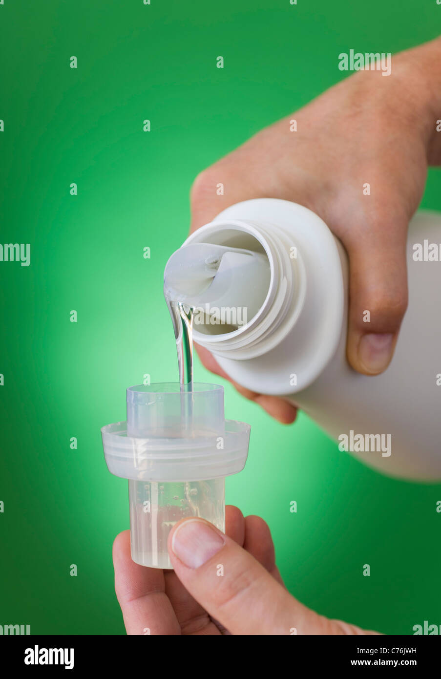 Hands pouring cleaning liquid Stock Photo Alamy