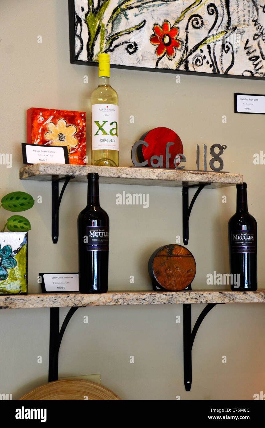 Wine bottles and knick knacks on a shelf Stock Photo