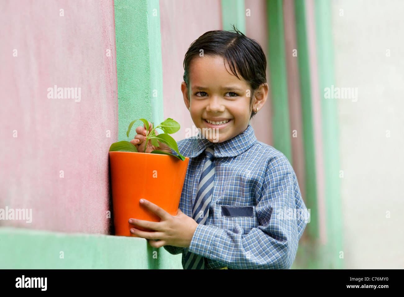 School girl holding a potted plant Stock Photo - Alamy