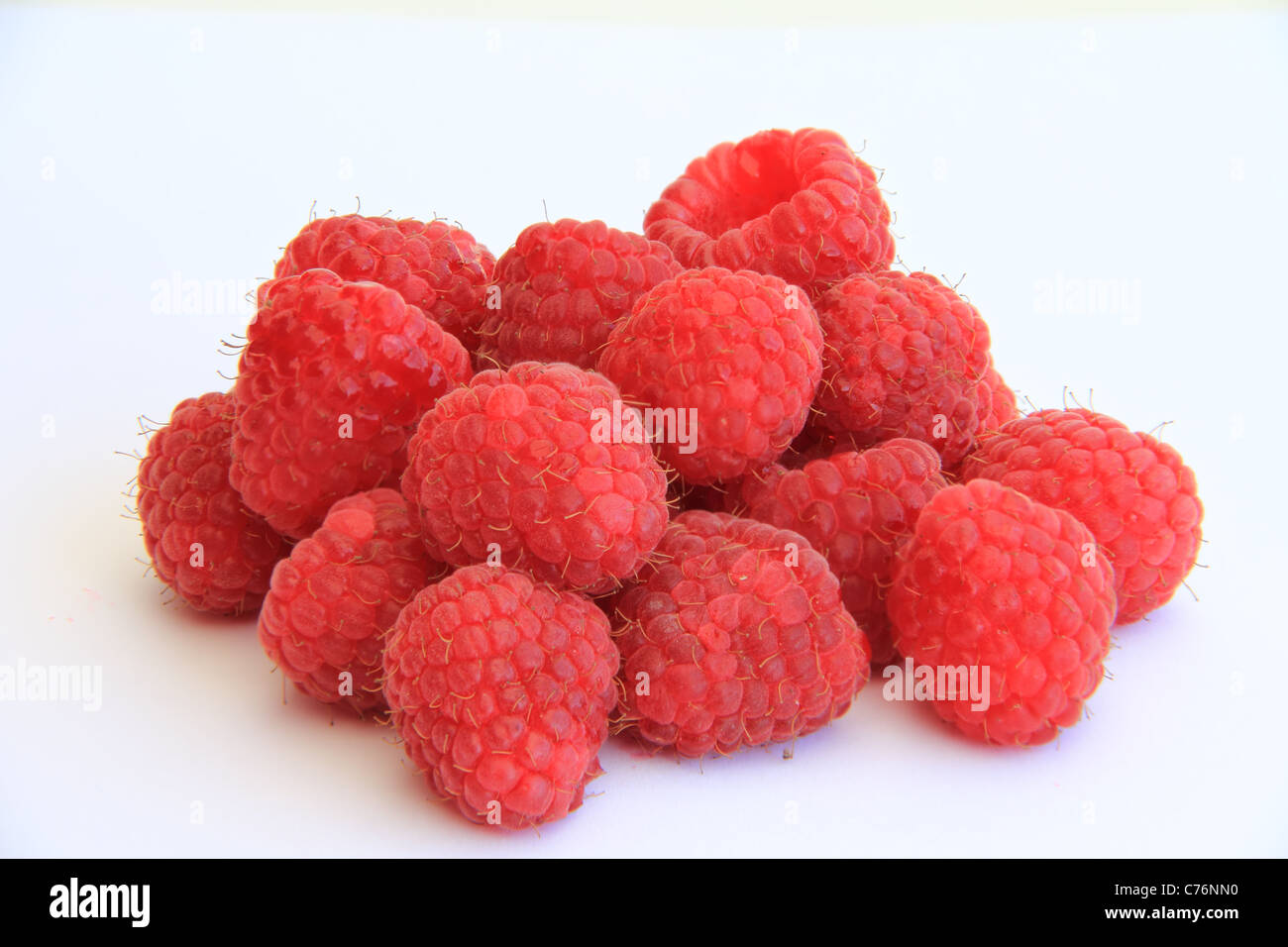 stack of delicious organic raspberries on white background Stock Photo ...