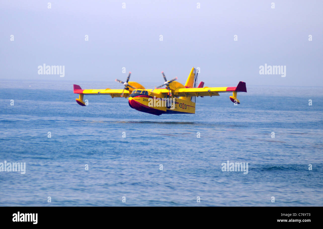 Bombardier/Canadair CL415 fire bomber collecting seawater, Calahonda, Costa del Sol, Malaga Province, Andalucia, Spain. Stock Photo