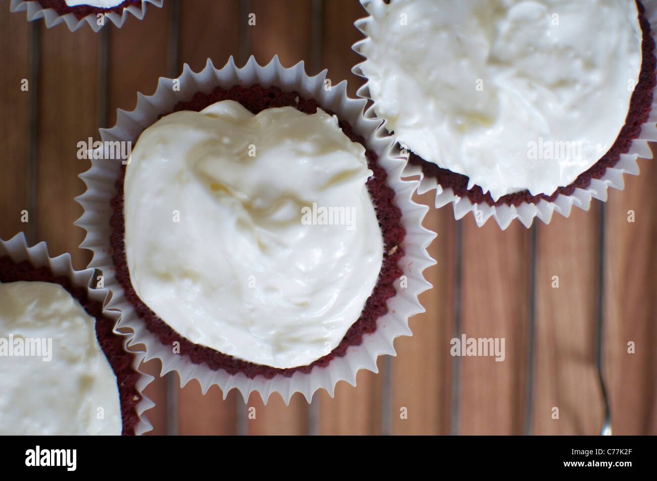Cupcakes iced on a cooling rack. Stock Photo