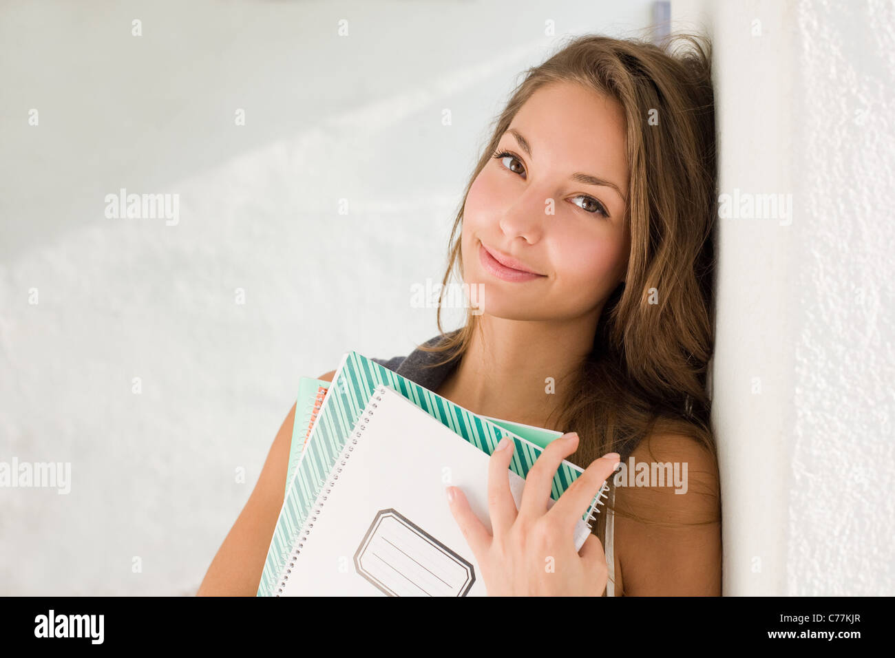 Portrait of a gorgeous young student girl holding exercise books Stock ...