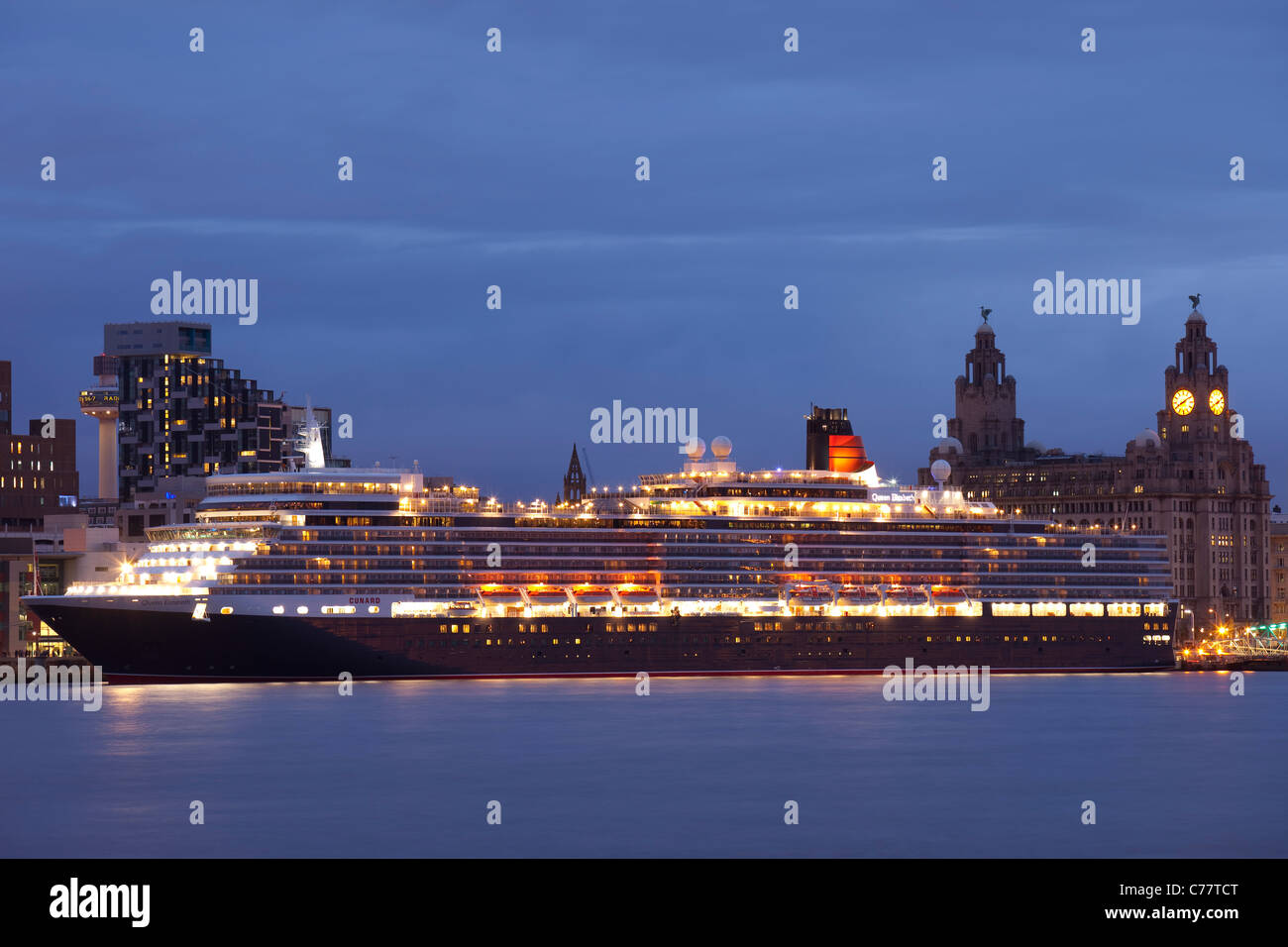 The Queen Elizabeth cruise liner moored at the Liverpool terminal, with the Liver Building visible behind her. Stock Photo