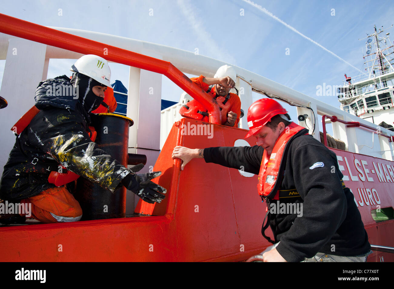 A worker transfers from a crew transfer vessel to a cable laying vessel