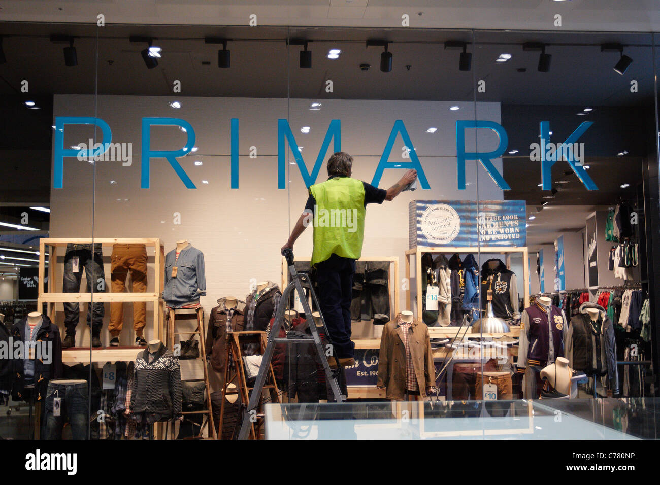 A workman puts finishing touches to Primark in Westfield Stratford City