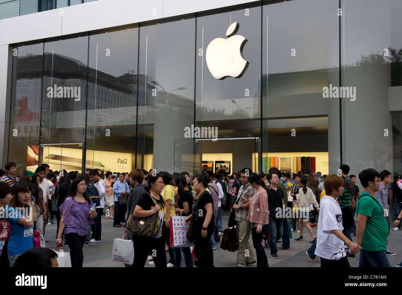 Pedestrians walk past an Apple Inc. store in Beijing, China.11-Sep-2011 Stock Photo