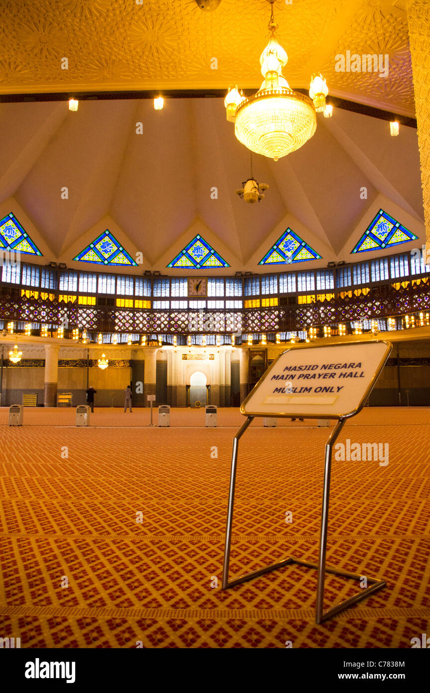 Prayer hall of national mosque of Malaysia in kuala lumpur, with a sign indicating 'muslim only'. Stock Photo