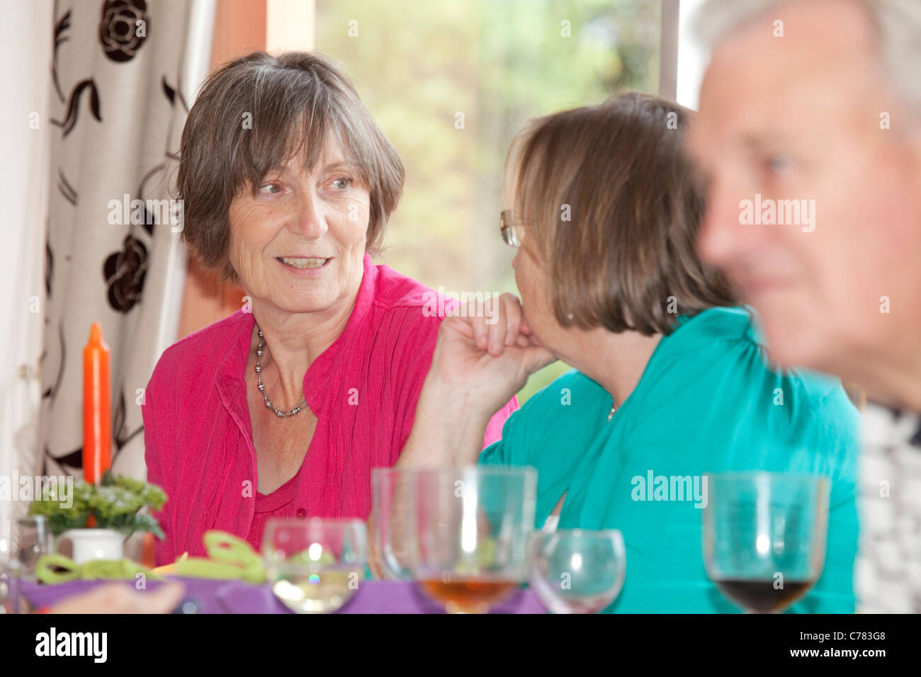 women sat chatting at sunday lunch Stock Photo