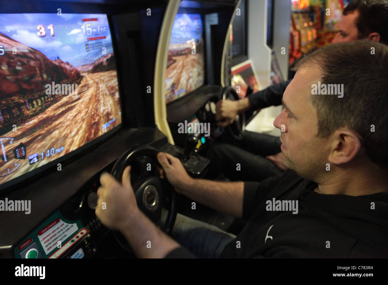 man playing on arcade machine, Stock Photo