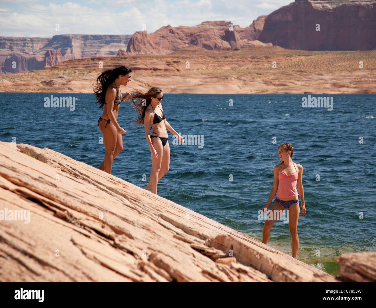 USA, Utah, Lake Powell, Three young women in bikini on lakeshore Stock