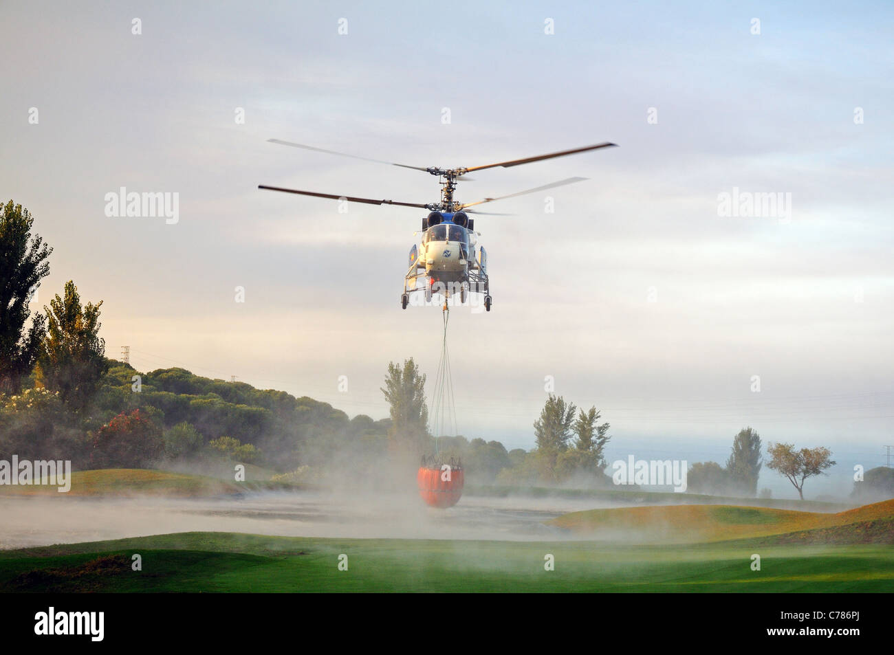 Kamov Ka-32A11BC helicopter collecting water, Cabopino Golf, Costa del Sol, Malaga Province, Andalucia, Spain, Western Europe. Stock Photo