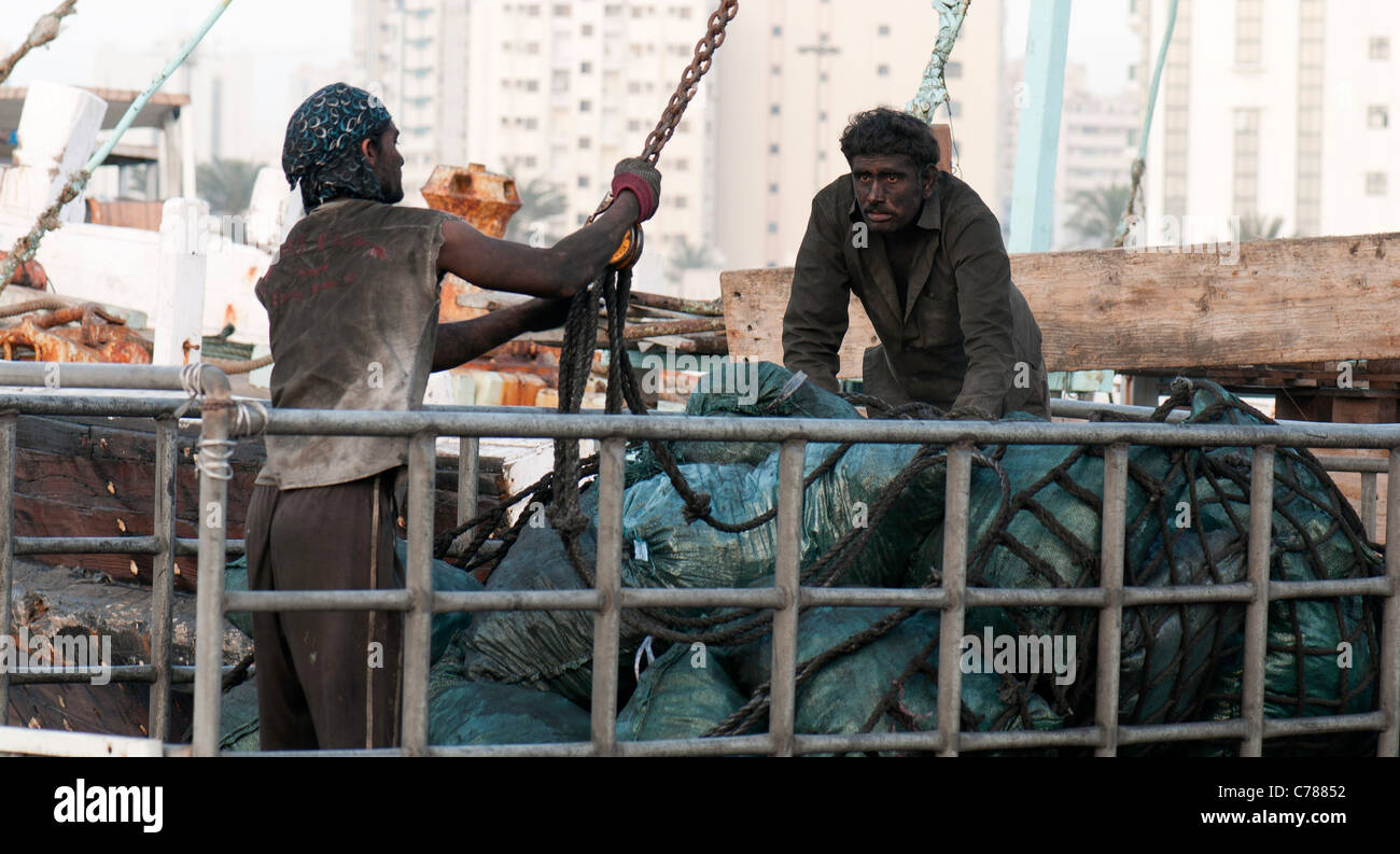 Workers dealing with charcoal in Sharjah Stock Photo