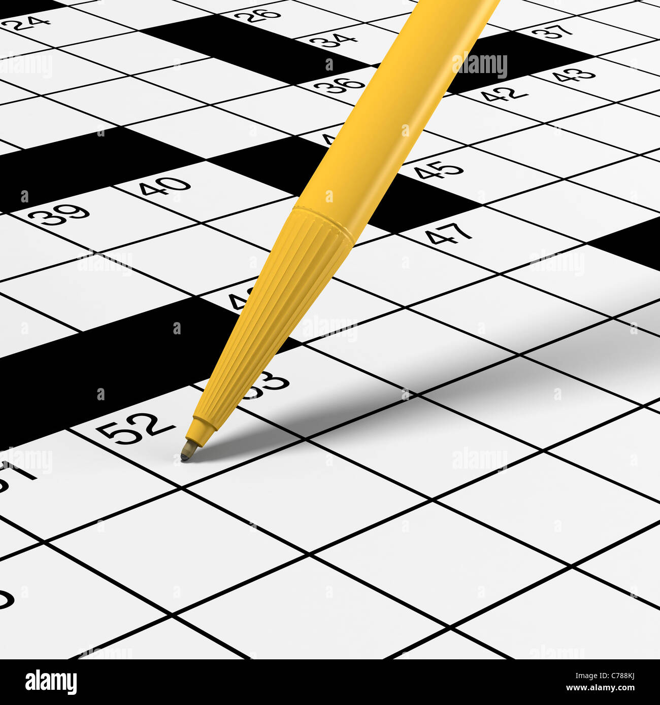 Crossword puzzle detail with yellow ballpoint pen ready for solving