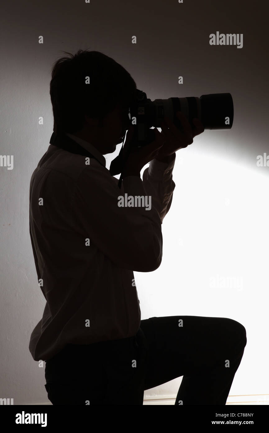Silhouette of a photographer. Stock Photo