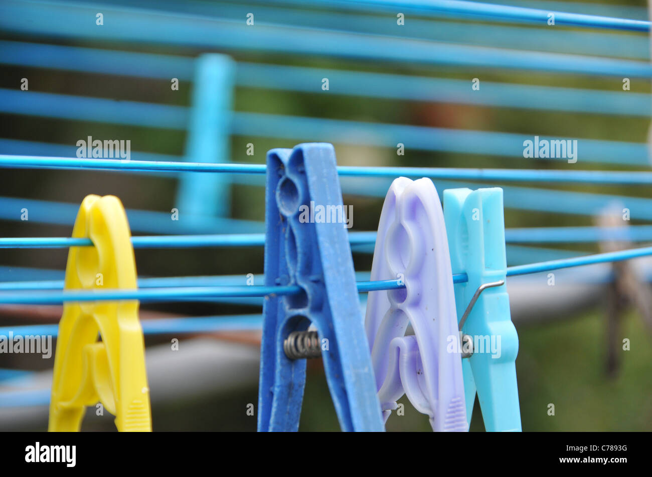 Clothes pegs washing line out of focus plastic bright colours Stock Photo