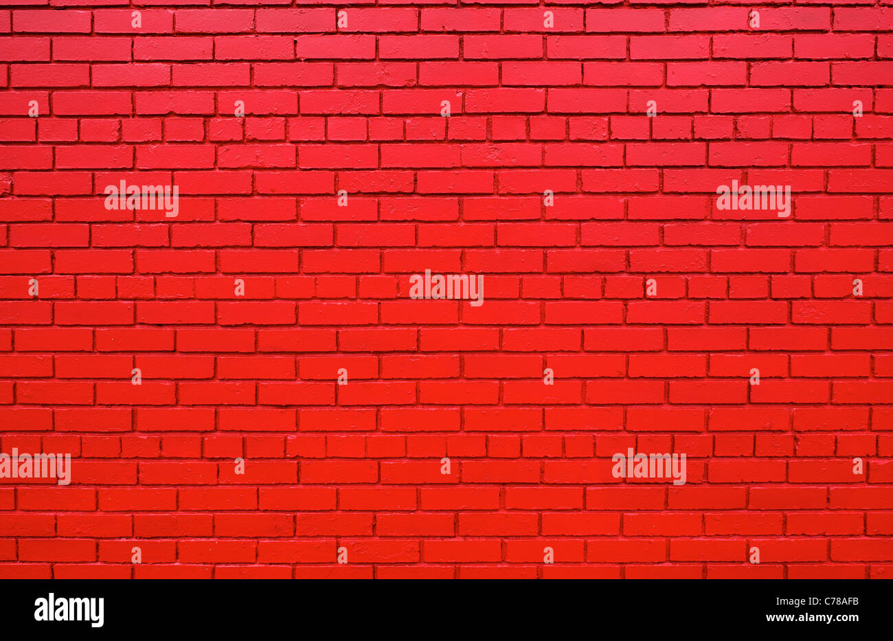 Large brick wall that has been painted lipstick red Stock Photo