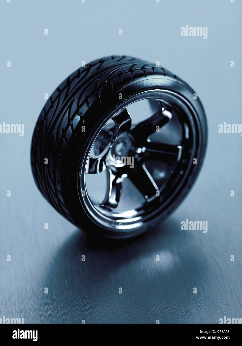 Rubber tyres with sports rims on a silver background Stock Photo - Alamy