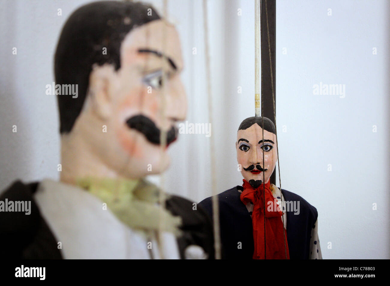 Close of of a large male Sicilian marionette / puppet with mustache out of focus. Focus on puppet in the background Stock Photo