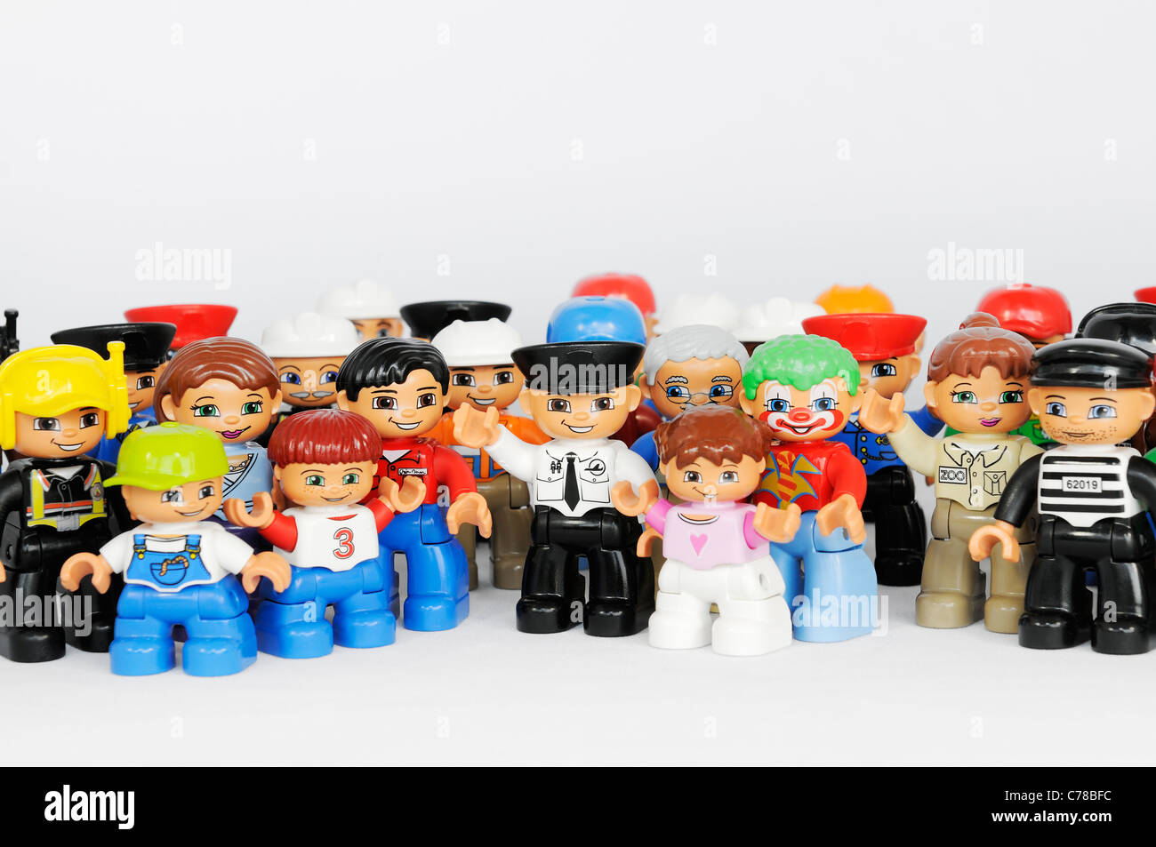 A group of Lego brand Duplo Figures with happy faces Stock Photo