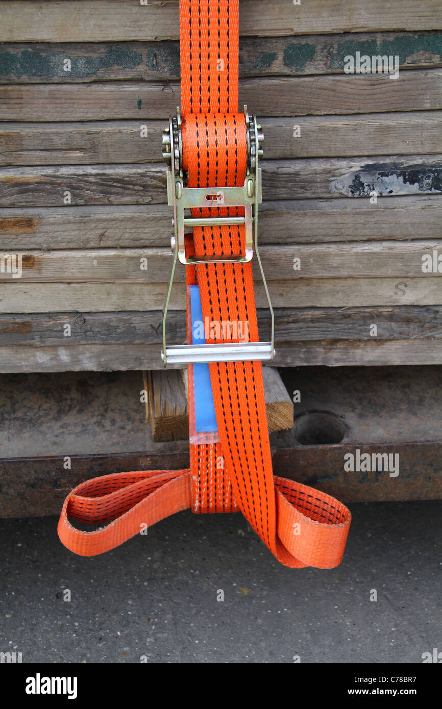 Modern new heavy duty luggage load strap on wooden boards. Stock Photo
