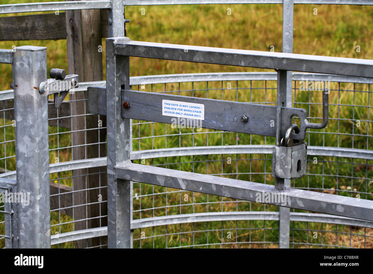 Galvanized modern gate latch with padlock Stock Photo Alamy