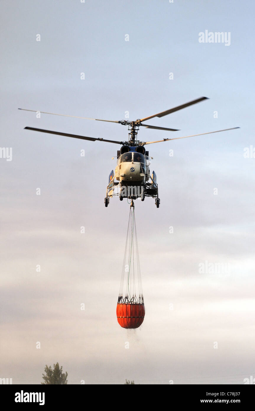 Kamov Ka-32A11BC helicopter carrying water for fire, Cabopino Golf, Costa del Sol, Malaga Province, Andalucia, Spain, Europe. Stock Photo