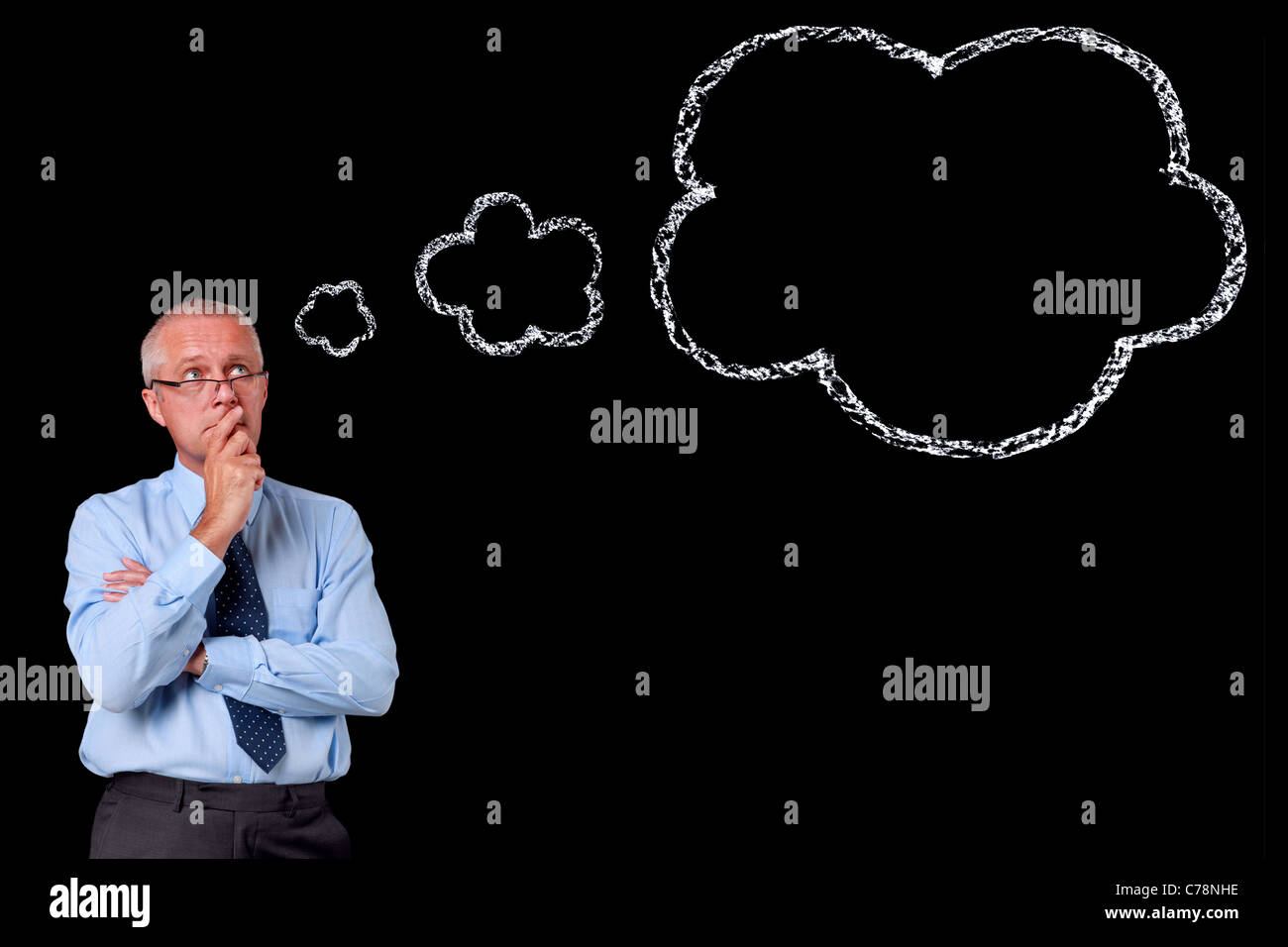 Photo of a mature businessman against a black background, chalk thought bubble with copy space to add your own text. Stock Photo