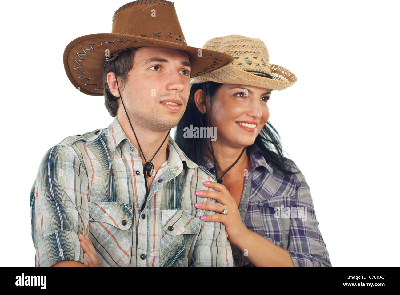 Happy couple with cowboy hats looking to the future isolated on white  background Stock Photo - Alamy
