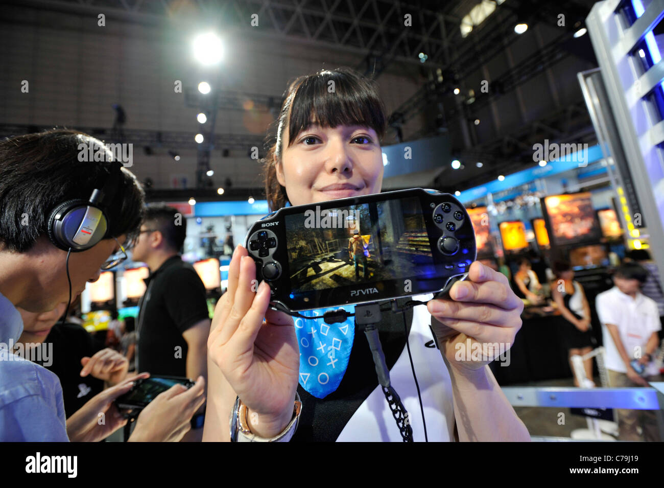 A booth demonstrator at Sony Computer Entertainment Inc.'s booth demonstrates the company's PSVita at the Tokyo Game Show 2011 Stock Photo
