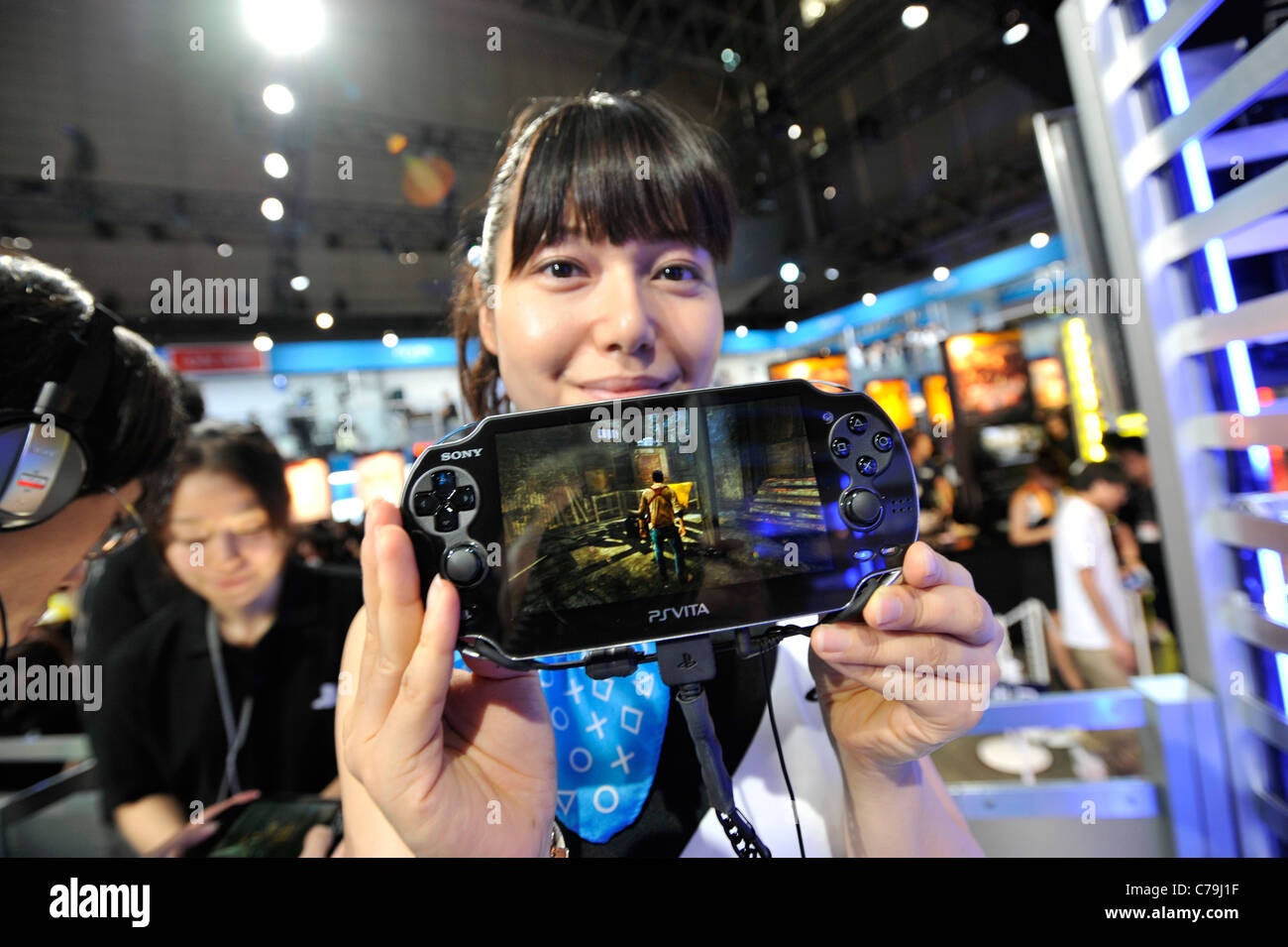 A booth demonstrator at Sony Computer Entertainment Inc.'s booth demonstrates the company's PSVita at the Tokyo Game Show 2011 Stock Photo