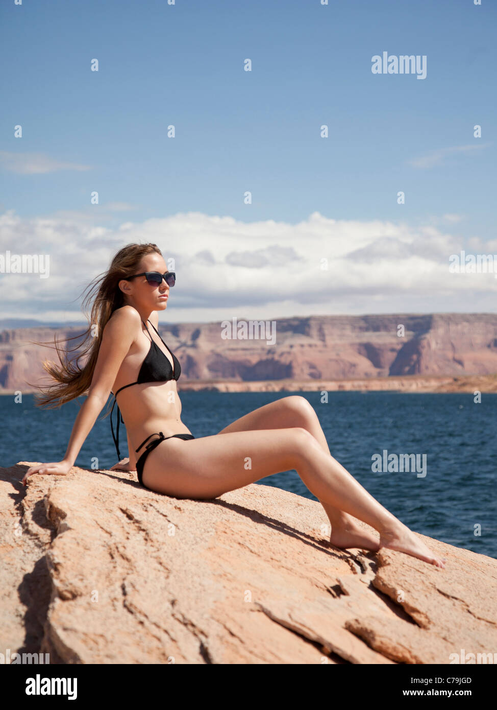 USA, Utah, Lake Powell, Young woman wearing bikini sunbathing and looking away Stock Photo