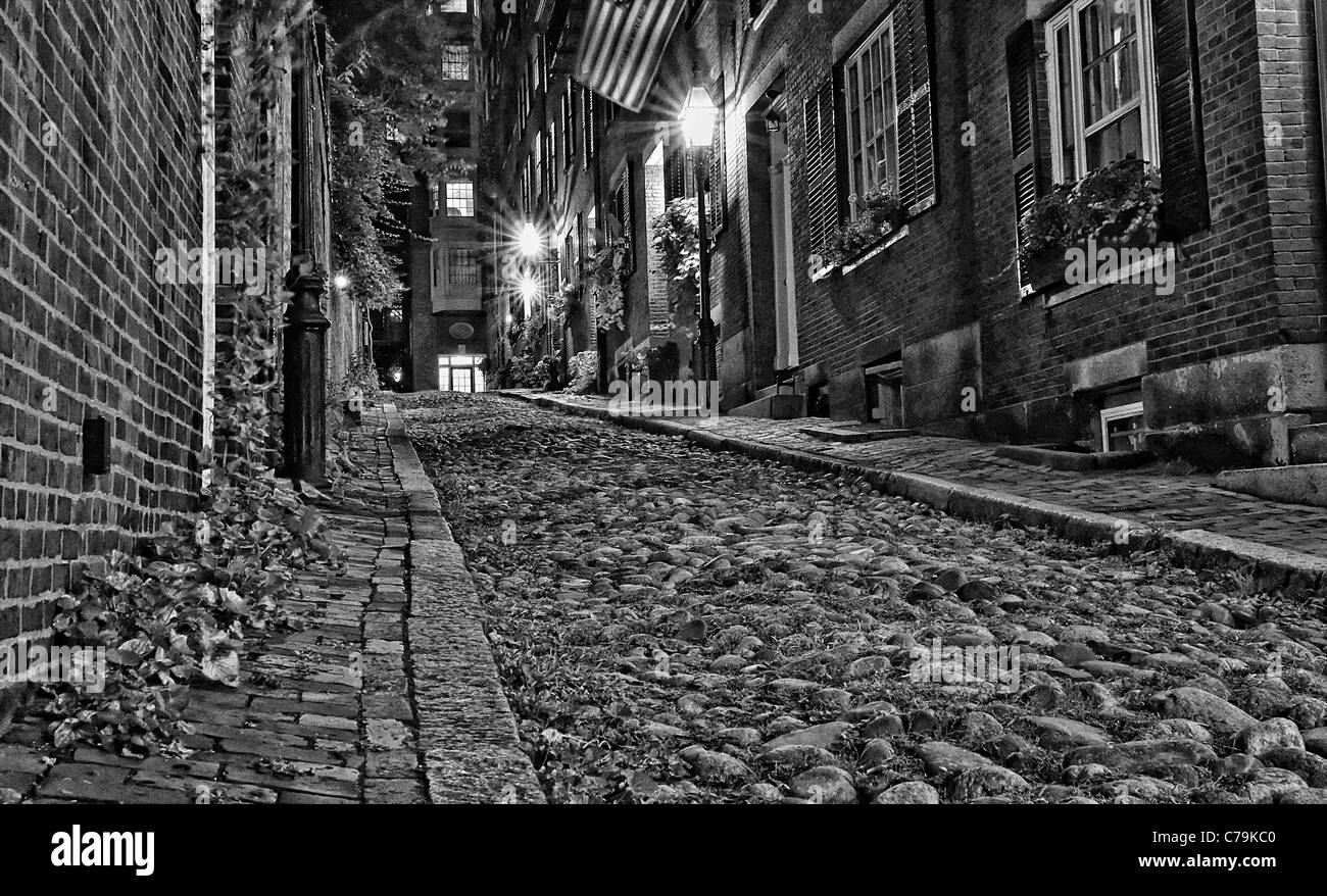 Black and white night image of an old 19th century cobble stone road in boston massachusetts