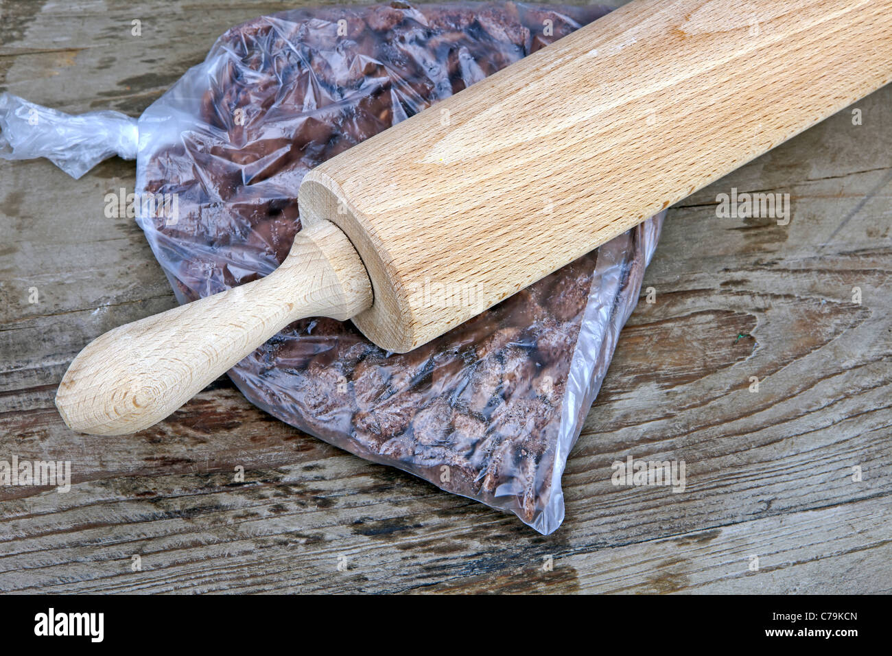 with a rolling pin to be crushed chocolate cornflakes Stock Photo