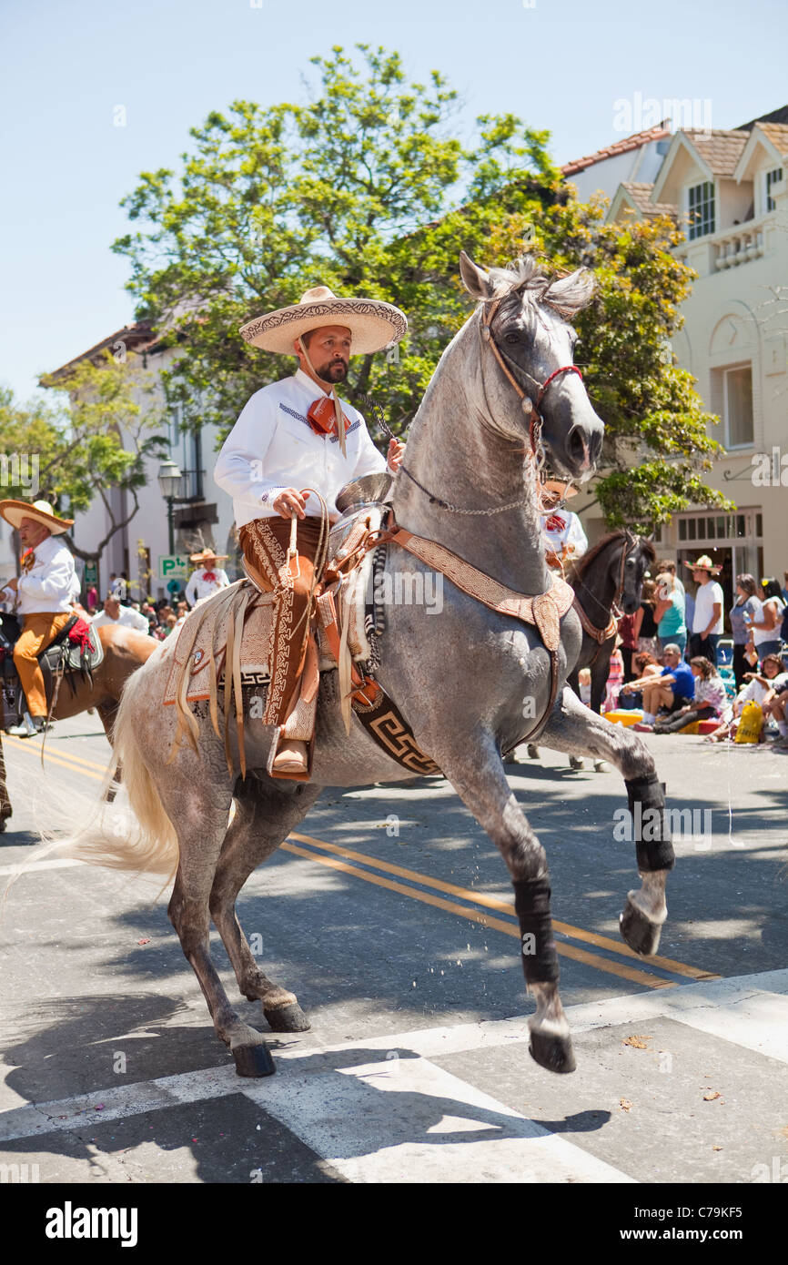horse rears while Hispanic horseback rider participates in the parade of Old Spanish Days Fiesta, Santa Barbara, California Stock Photo