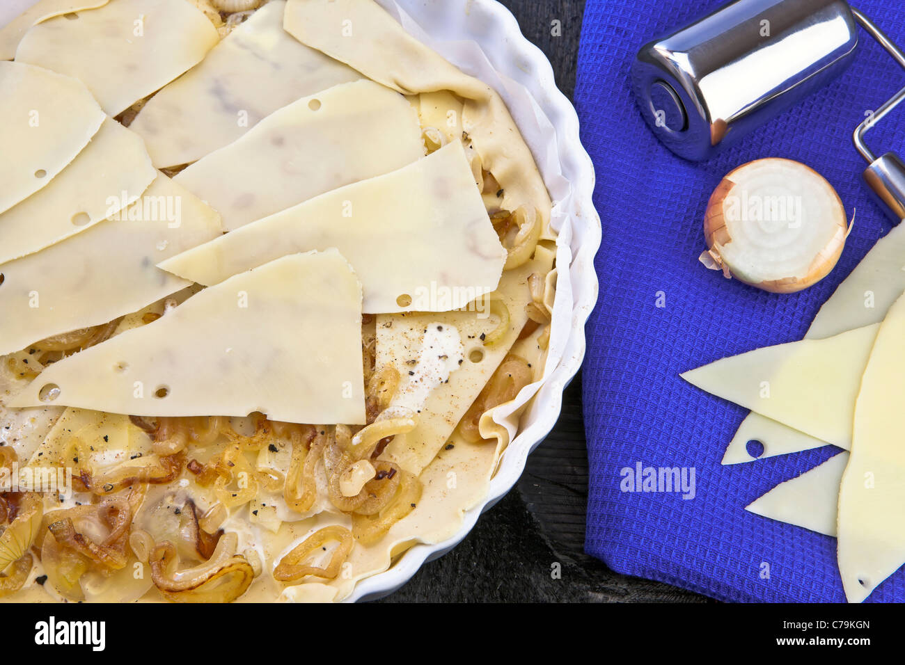 Dough with onions and swiss cheese mountain Stock Photo