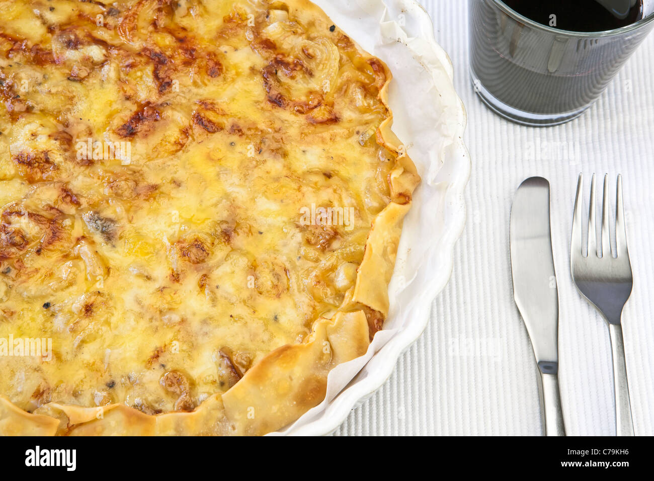 Tartform one with an onion-cheese tart and a glass of red wine Stock Photo