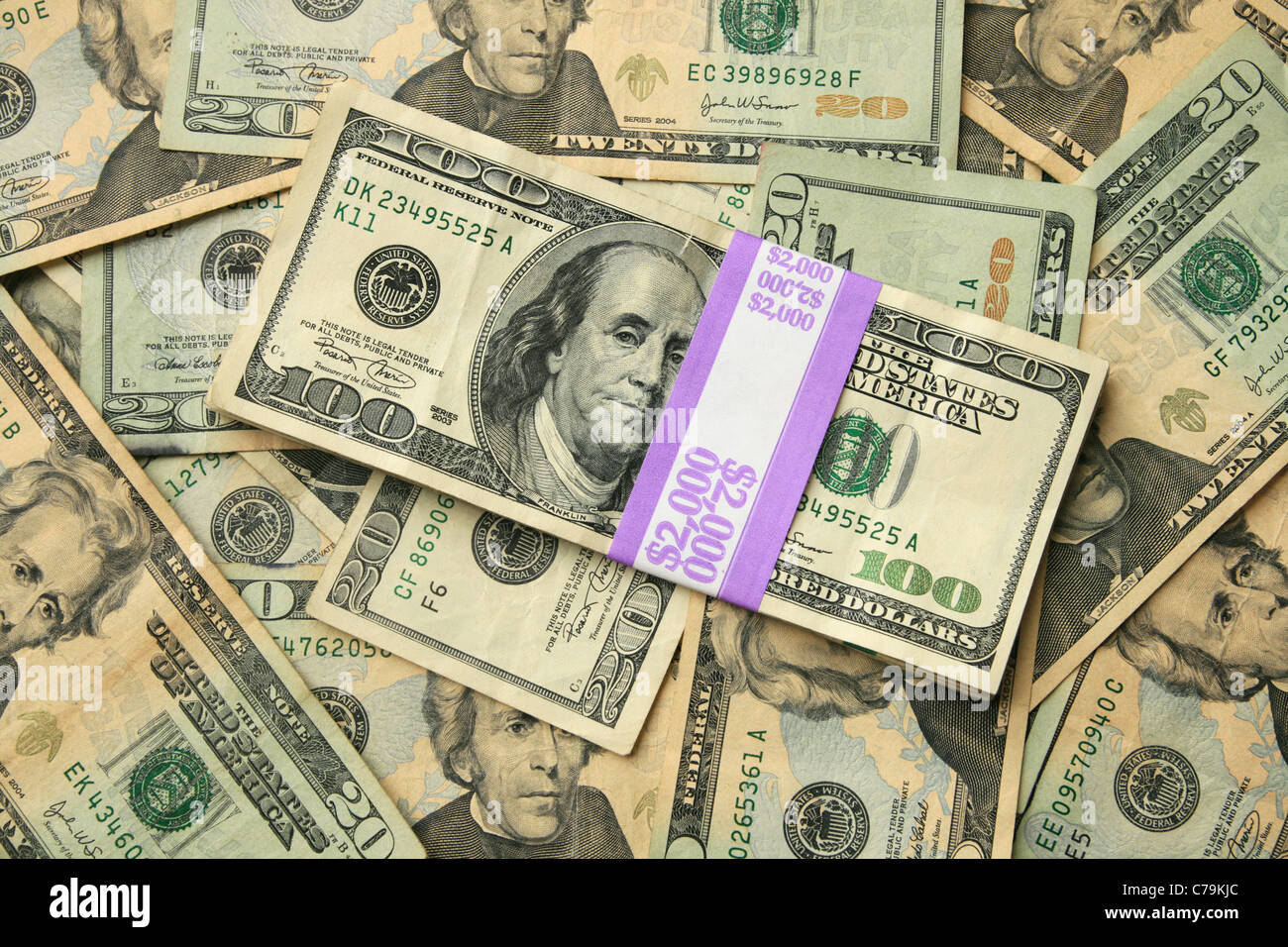 two thousand dollars in 100 bills on a background of twenty dollar US bills Stock Photo