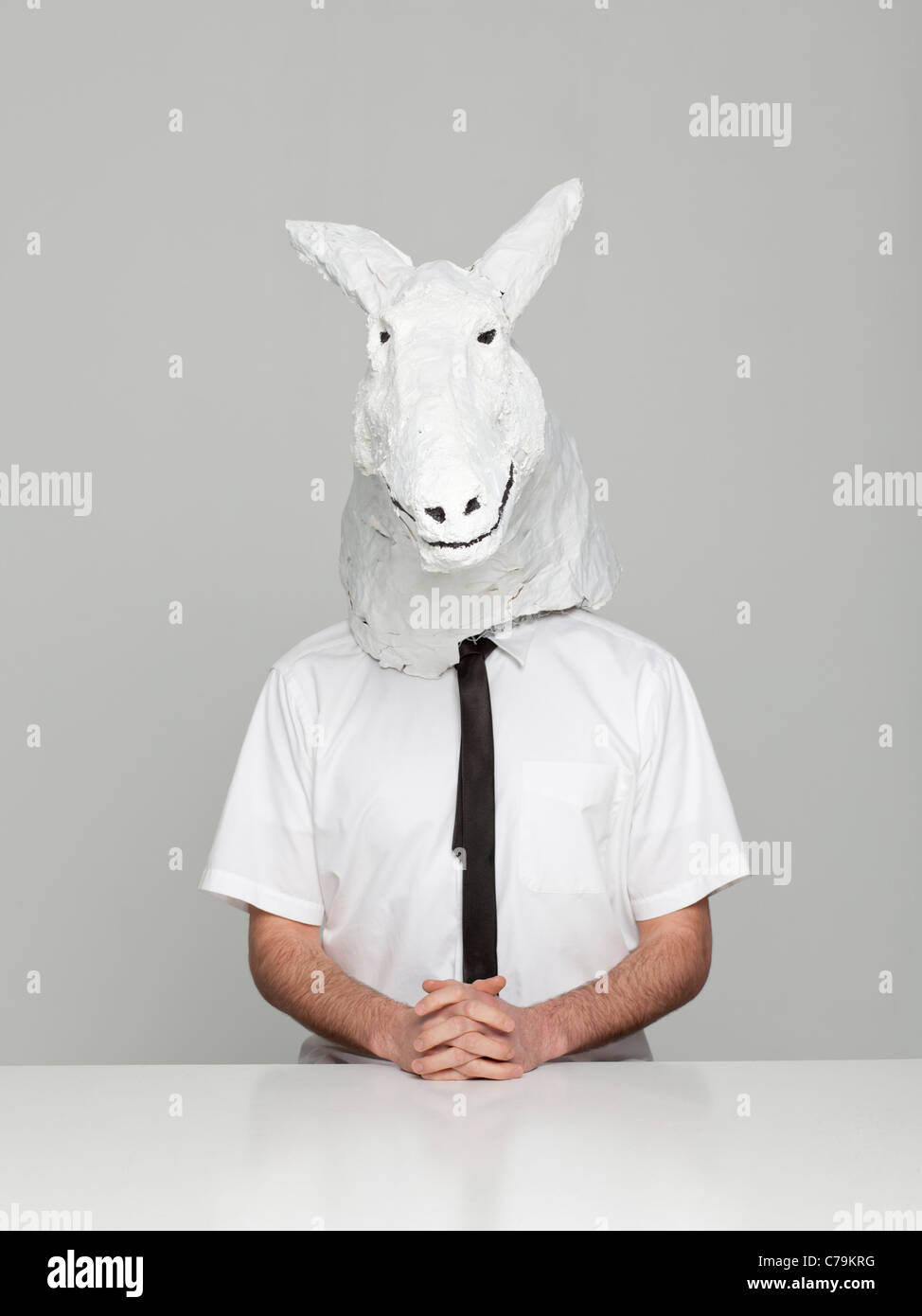 Studio portrait of young man wearing horse mask Stock Photo Alamy