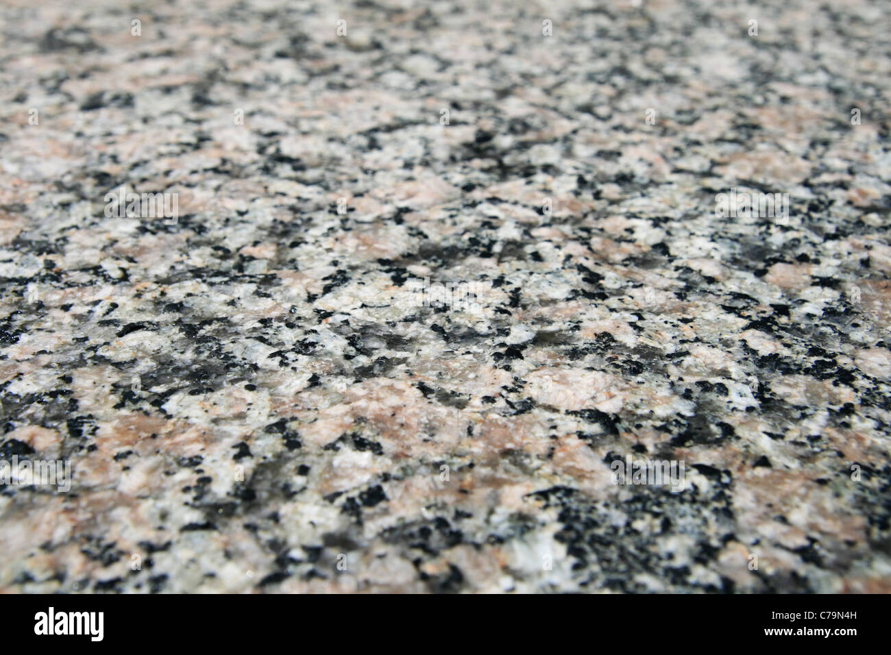 granite rock surface viewed from an angle with selective focus and shallow depth of field Stock Photo