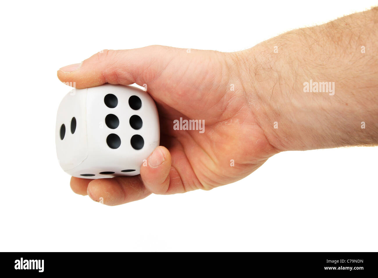 a man's hand rolling a giant white die isolated on white Stock Photo